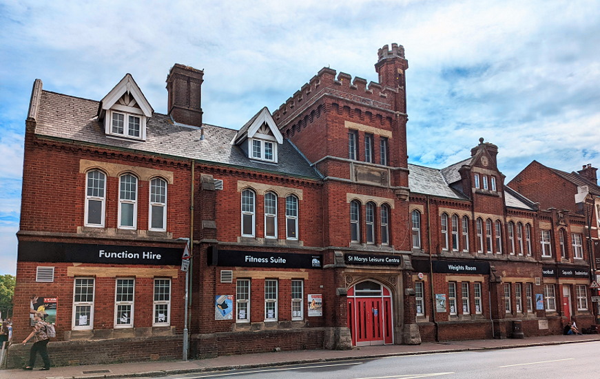 A red brick structure with a clock tower, showcasing classic architectural design.